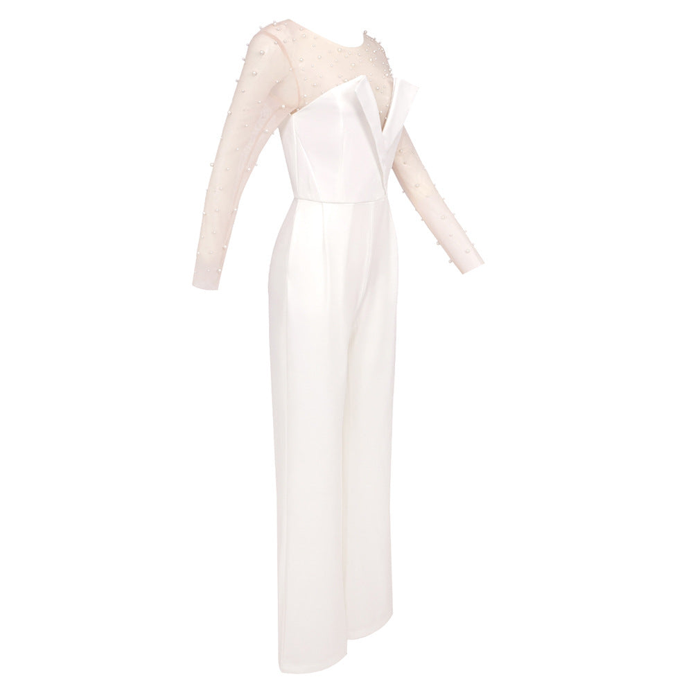 Elegant white jumpsuit with a sheer pearl-embellished bodice and wide-leg pants