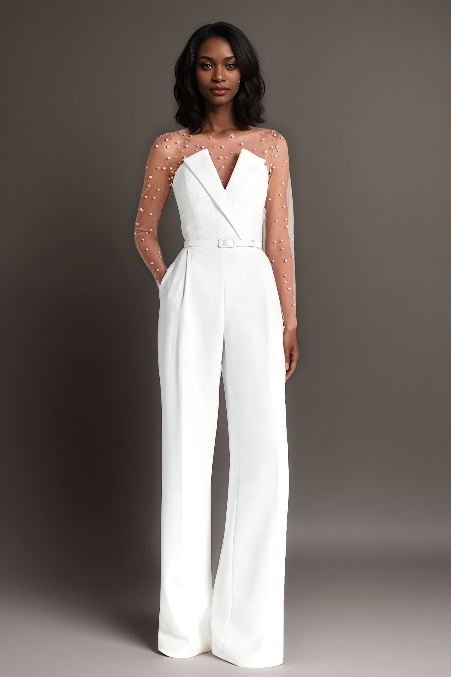 Elegant white jumpsuit with a sheer pearl-embellished bodice and wide-leg pants