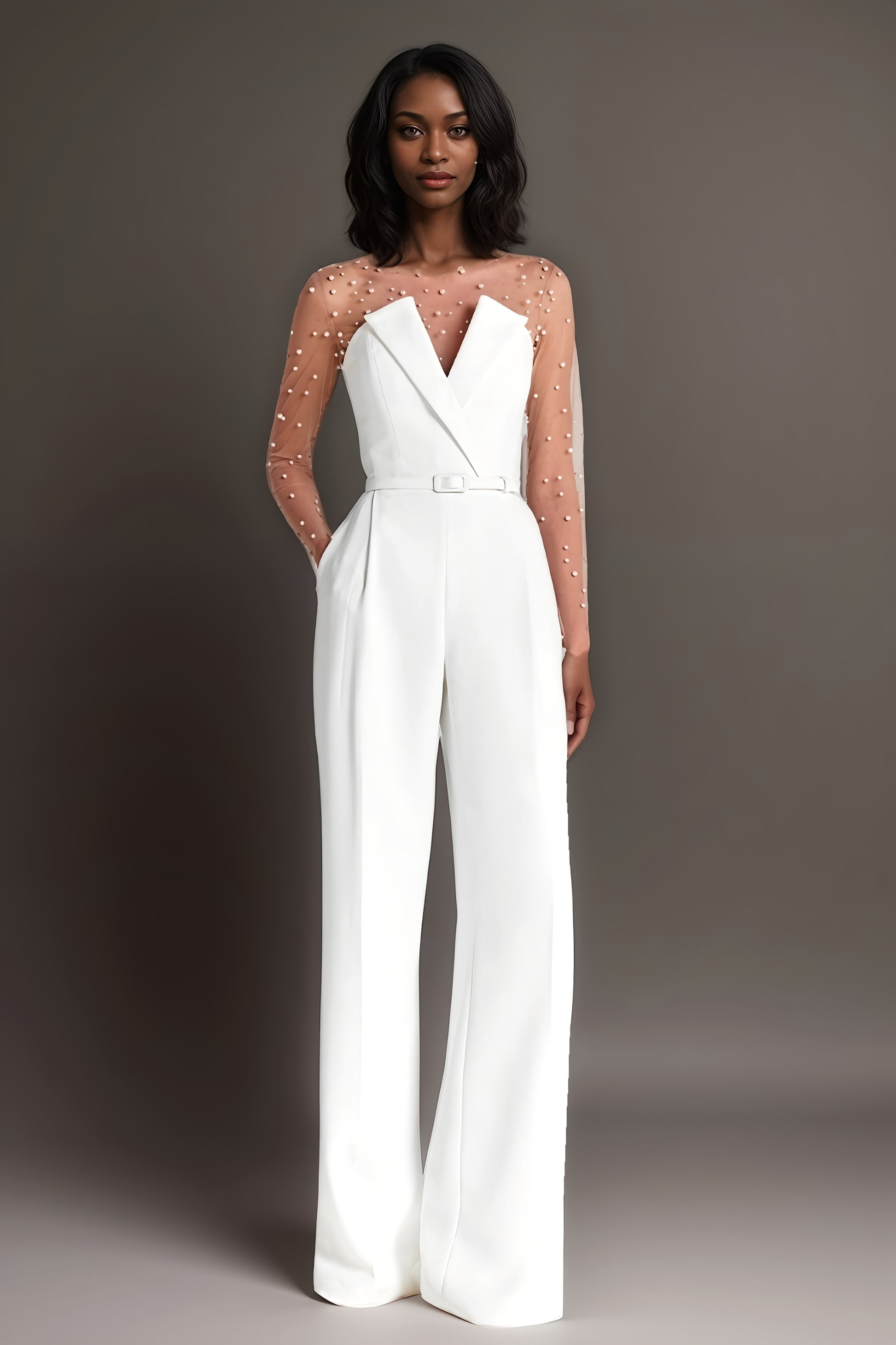 Elegant white jumpsuit with a sheer pearl-embellished bodice and wide-leg pants