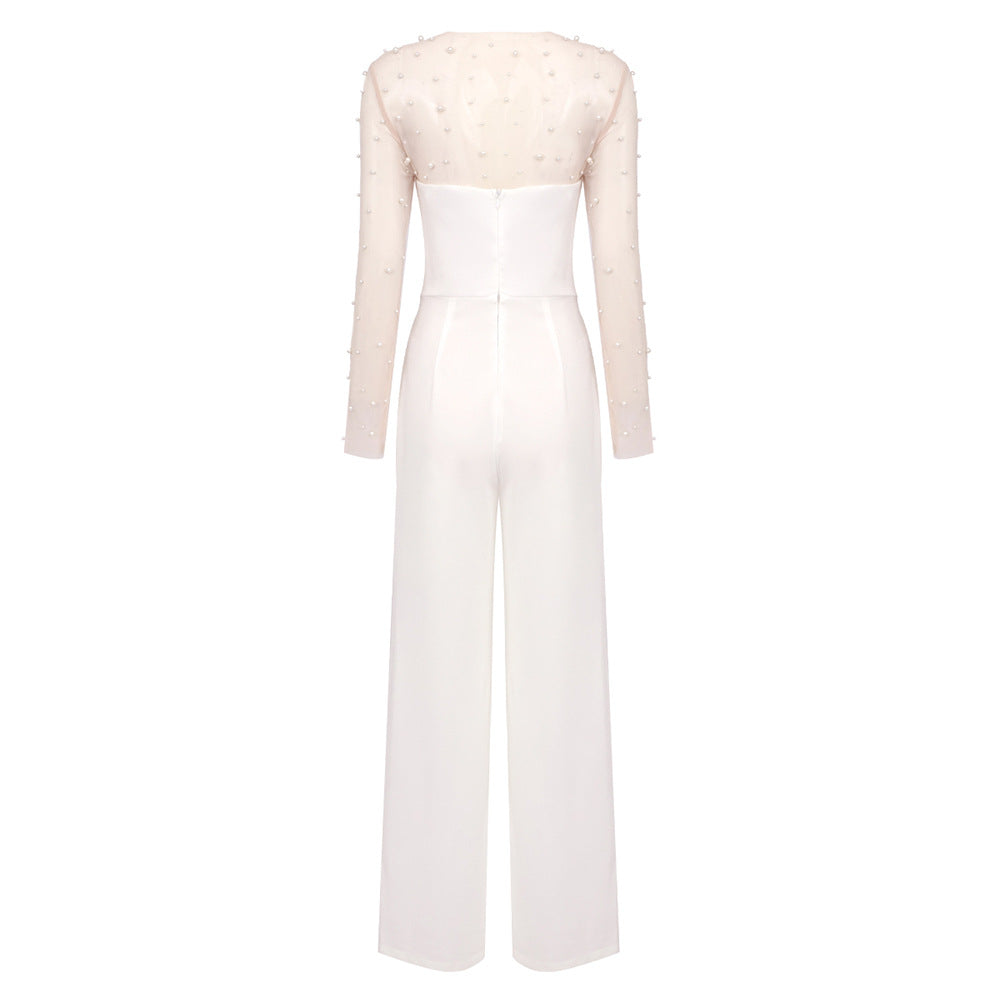 Elegant white jumpsuit with a sheer pearl-embellished bodice and wide-leg pants