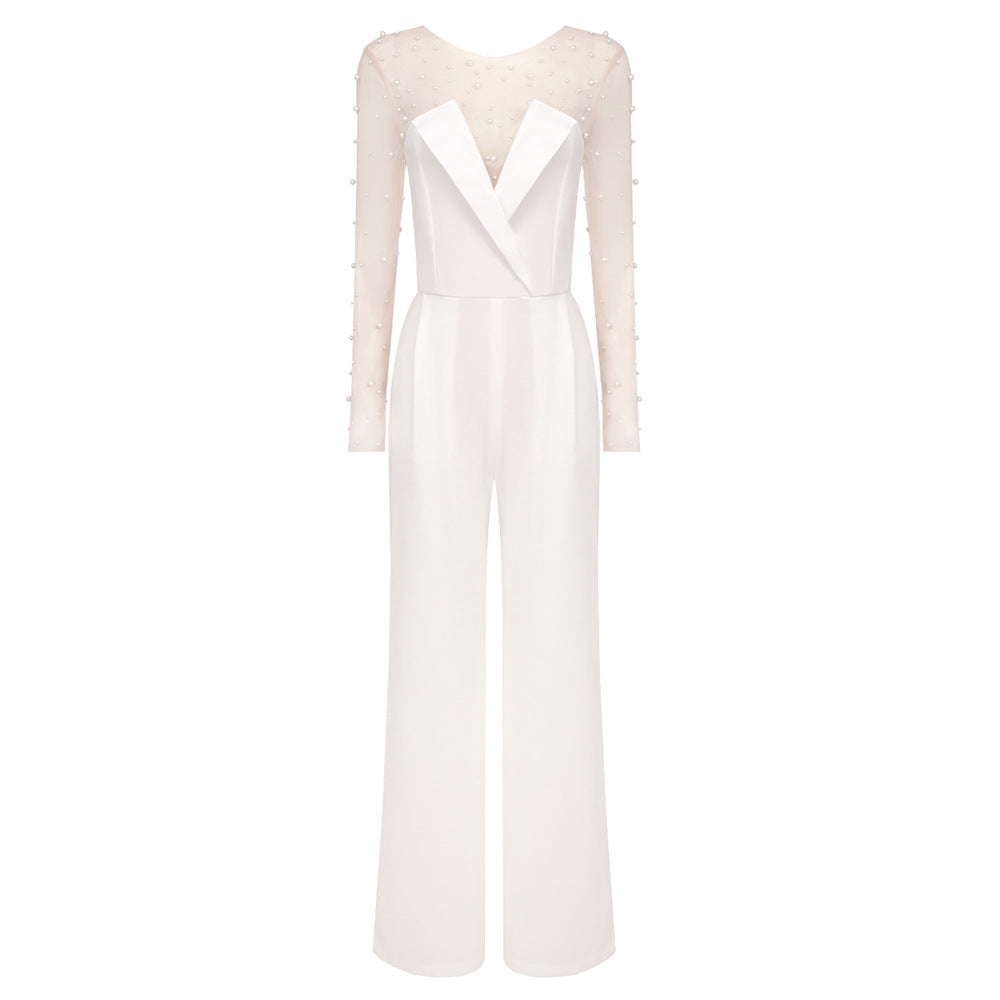 Elegant white jumpsuit with a sheer pearl-embellished bodice and wide-leg pants